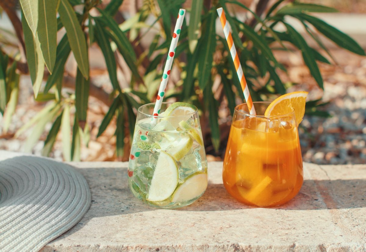 Two refreshing cocktails near a garden plants